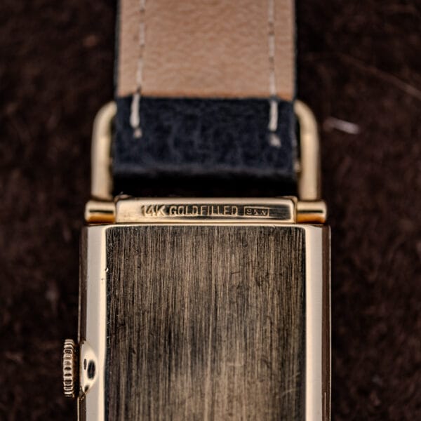 Hamilton Wilshire caseback stamping close-up reading 14K GOLD FILLED beside the case maker's cartouche
