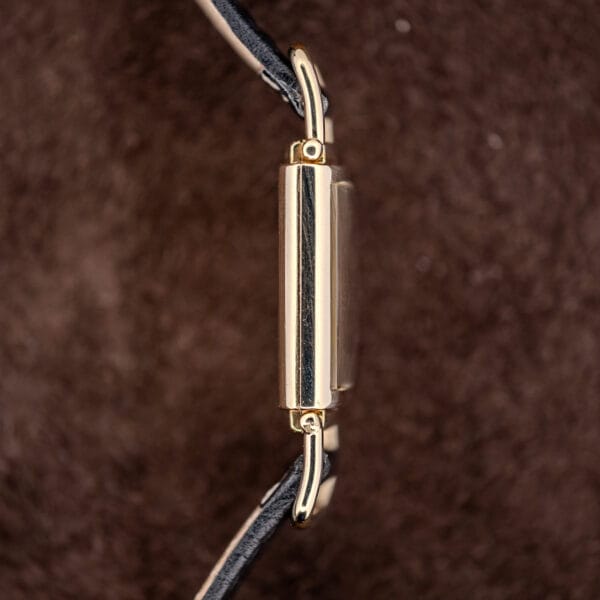 Hamilton Wilshire case flank and domed crystal, articulated gold filled lugs pivoting at each corner