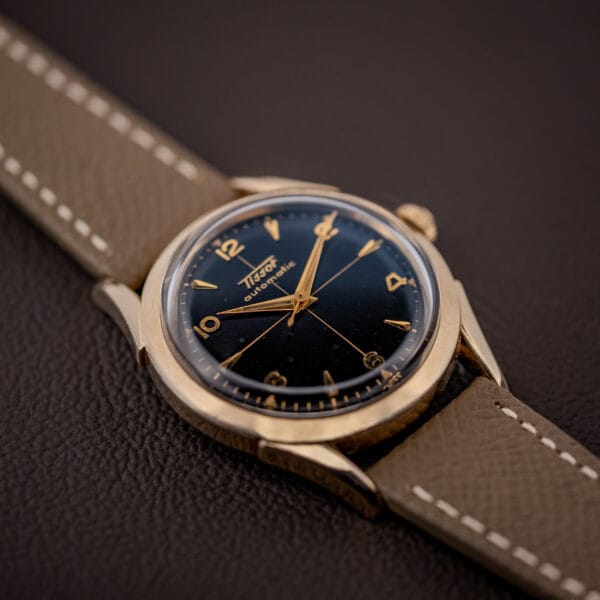 Vintage Tissot bumper automatic dial detail, gilt cross-hair and applied numerals against glossy black