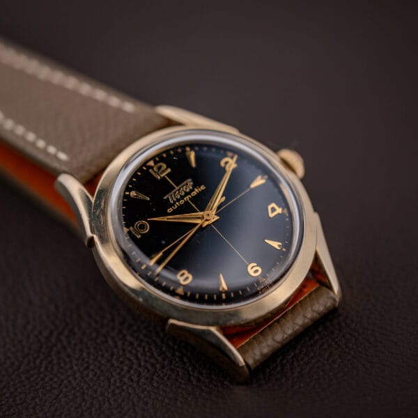 Tissot 28.5-21 dial macro, slim gold dauphine hands and central sweep seconds over glossy black gilt