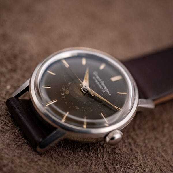 Girard-Perregaux Gyromatic dial in low light, olive-black tone with golden foxing near the center