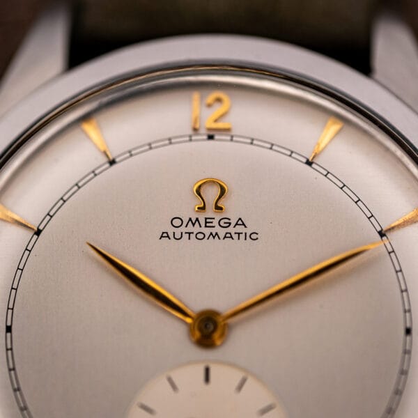 Macro of Omega 2421/4 dial showing gold applied Omega symbol, OMEGA AUTOMATIC printing and railroad minute track