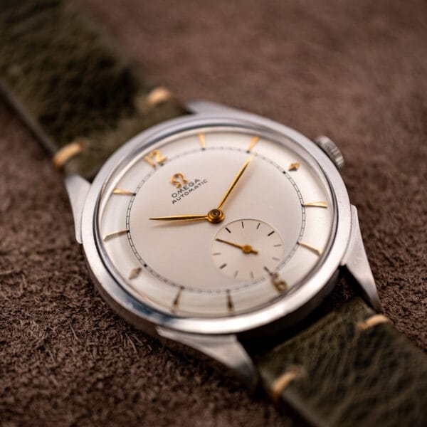 Omega automatic bumper 2421/4 at an angle, gold wedge markers and lozenges catching studio light