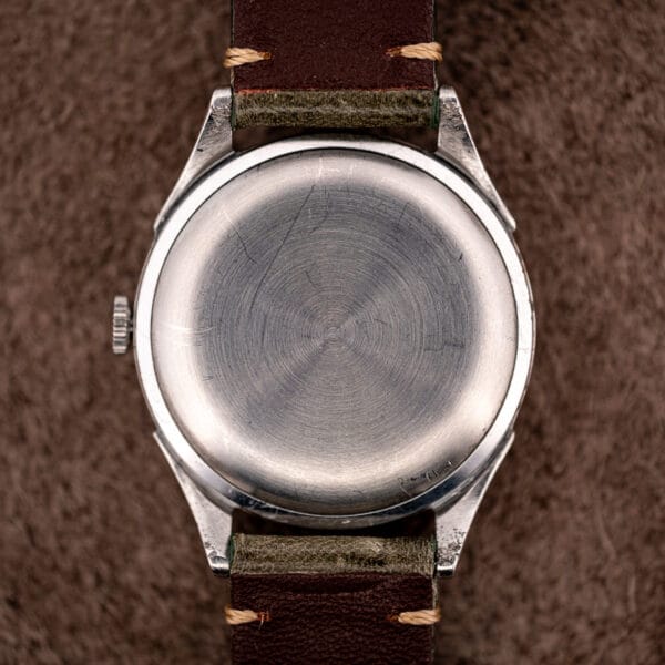 Omega 2421/4 plain stainless steel snap caseback with circular brushing and decades of honest hairlines