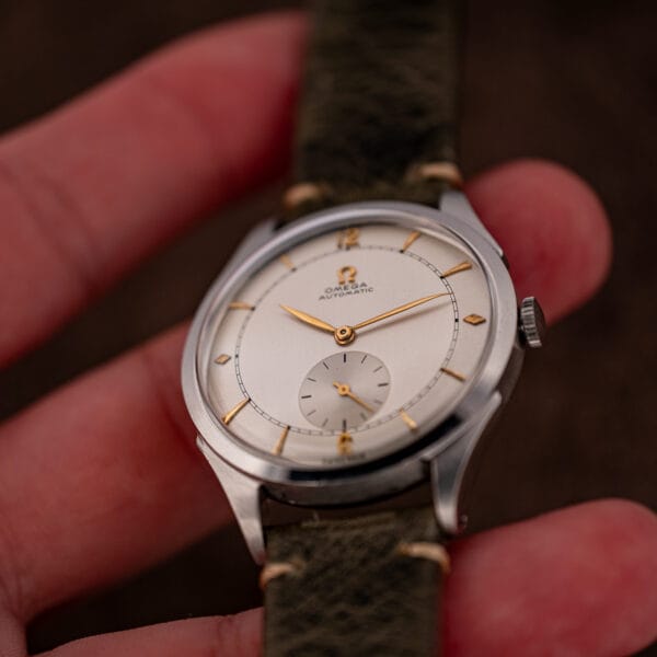 Omega automatic bumper 2421/4 held in hand showing 35mm stainless case scale and two-tone dial