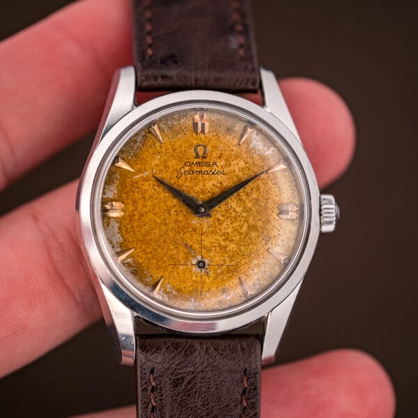Omega Seamaster 2937-5 held in hand, full freckled honey tropical dial and pink-gold applied markers