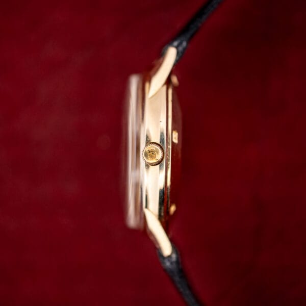 Side profile of LeCoultre Master Mariner 14k gold case with domed crystal and a monogrammed gold crown