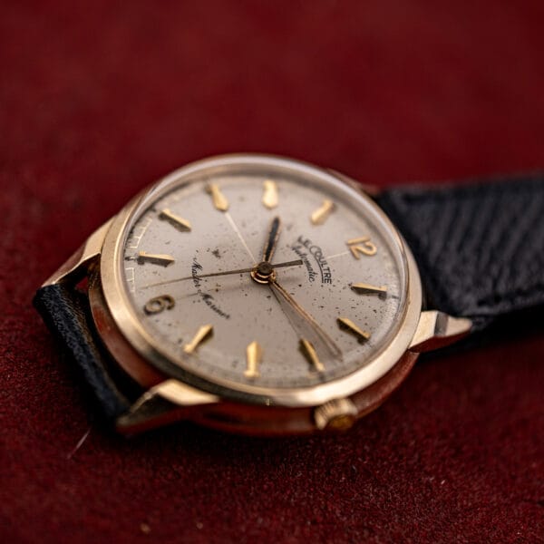 LeCoultre Master Mariner ref 395C463 gold case at a low angle, domed acrylic crystal over a cream patina dial