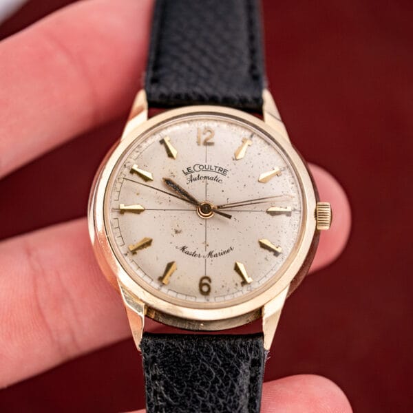 Vintage LeCoultre Master Mariner automatic held in hand, cream dial with applied gold markers in a 14k gold case