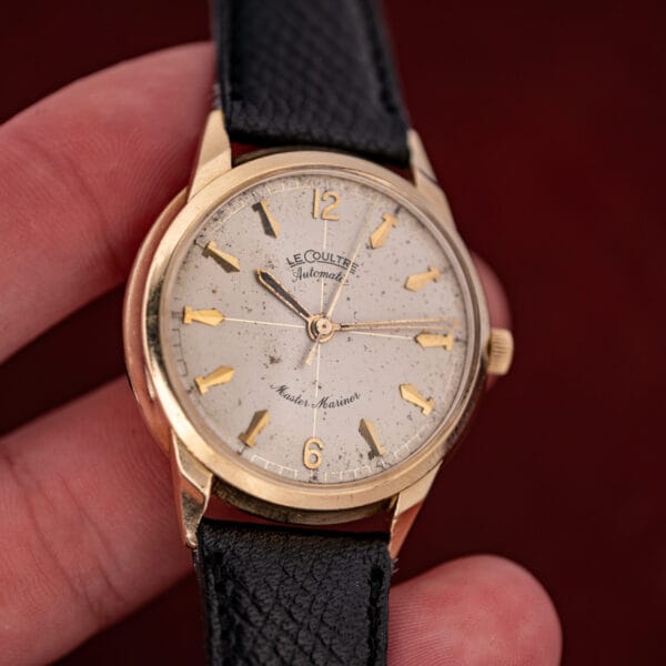LeCoultre Master Mariner 395C463 in hand showing 14k gold case wear, speckled cream dial and gold sweep seconds