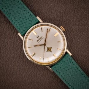 Vintage Omega Automatic ref. 14765 silver dial with applied gold batons and red-C logo cartouche on pine green strap
