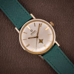 Vintage Omega Automatic ref. 14765 silver dial with applied gold batons and red-C logo cartouche on pine green strap