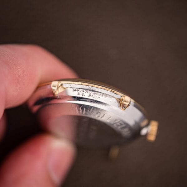 Case edge of the Omega Automatic stamped 14K GOLD BEZEL over S.S. BACK, an American-market contract case