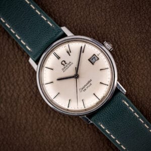 Omega Seamaster De Ville 166.020 with silver sunburst dial, applied baton markers, and framed date window at three.