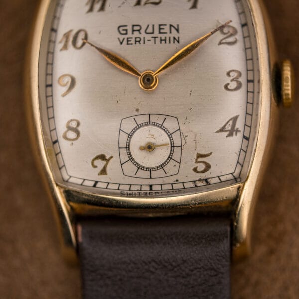 Macro of the Gruen Veri-Thin dial showing guilloche sub-seconds, gilt spear hands and SWITZERLAND printing at six
