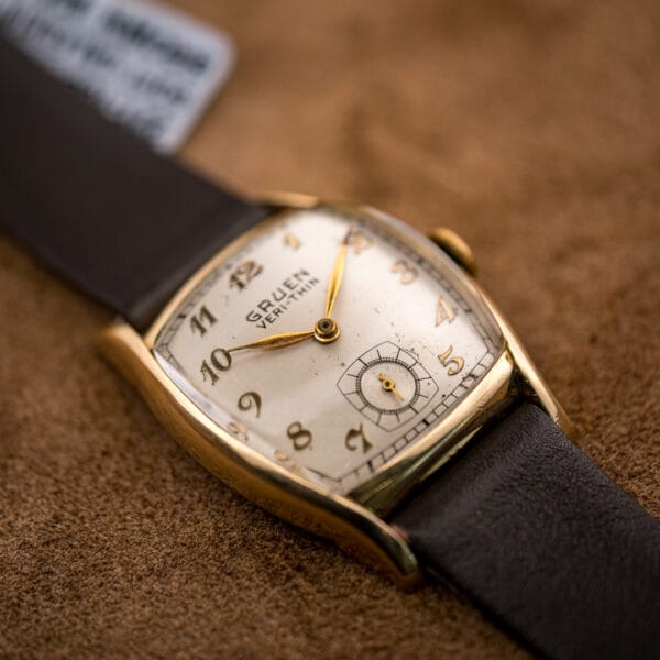 Angled view of the Gruen Veri-Thin 421-653 cushion tonneau case, gilt Arabic dial and crown at three