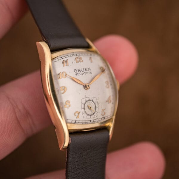 Gruen Veri-Thin ref 421-653 held in hand showing its compact 28mm tonneau dress proportions