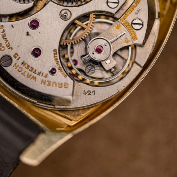 Macro of Gruen 421 movement showing the balance, F and S regulator index and the 421 caliber engraving