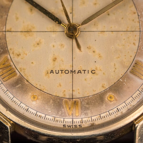 Longines 2030 lower dial macro reading AUTOMATIC and SWISS, with an applied gold VI, dot markers and railroad minute track