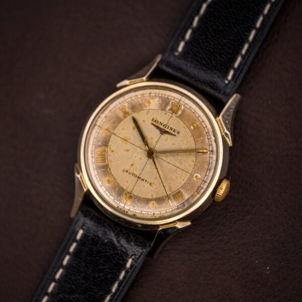 Longines Automatic Ref. 2030 tropical dial showing the segmented cross-hair, applied gold Roman numerals and honeyed foxing