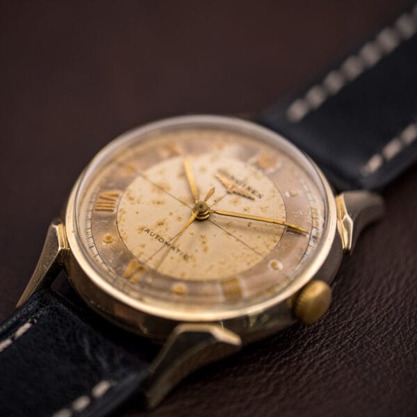 Vintage Longines 2030 three-quarter view showing the domed crystal, ribbed crown and sculptural faceted gold-filled lugs