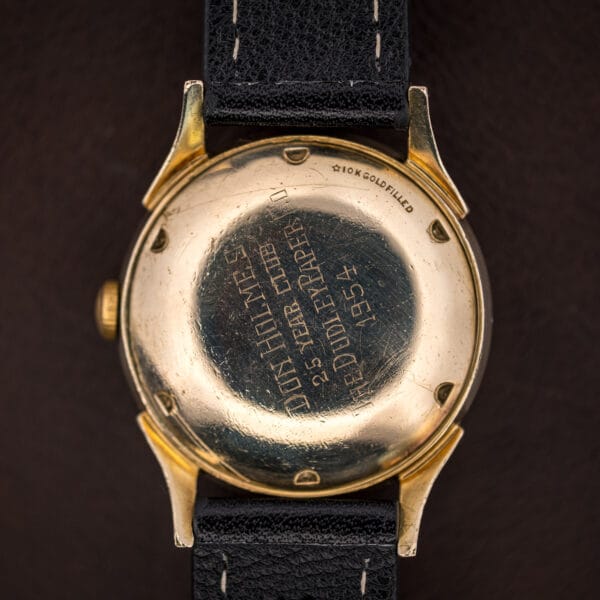 Close view of the Longines 2030 caseback presentation engraving in period Gothic script beside the 10K GOLD FILLED mark
