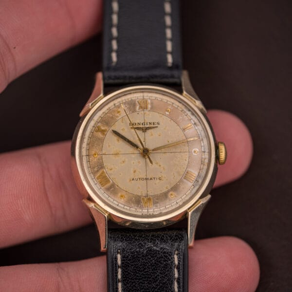 Vintage Longines Automatic Ref. 2030 held in hand, showing its scale and the warm tropical cross-hair dial