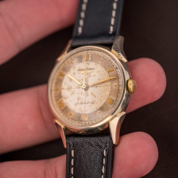 Longines Ref. 2030 gold-filled dress watch in hand, foxed champagne dial with faceted lugs and gold crown