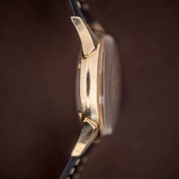 Longines Ref. 2030 full side profile, gold-filled case with a domed acrylic crystal and flared faceted lugs