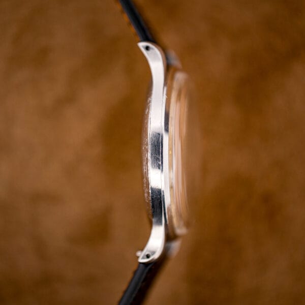 Edge-on profile of the Omega 2256/1 showing case thickness, faceted lugs and honest polishing marks