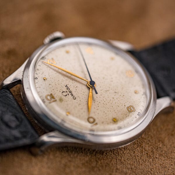 Raked view of the Omega Jumbo 2256/1 dial, gilt numerals and central seconds hand catching the light