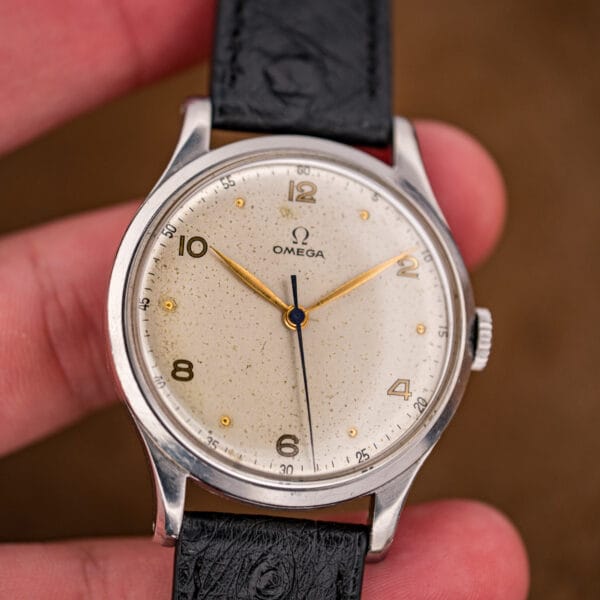 Omega Jumbo 2256/1 held in hand showing the oversized stainless steel case and warm cream dial