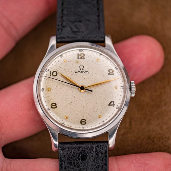 Omega Jumbo ref. 2256/1 in hand showing the full silvered dial, gold dot markers and signed Omega crown
