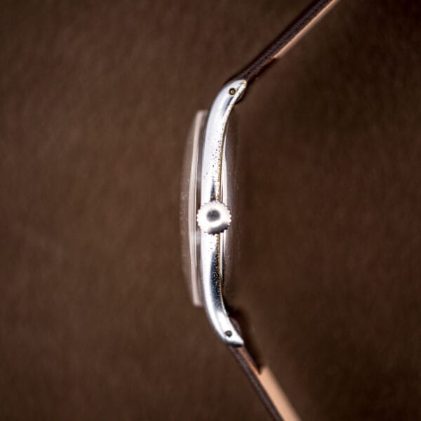 Side profile of the Tissot 6439-2 showing the domed acrylic crystal and chromed case band.