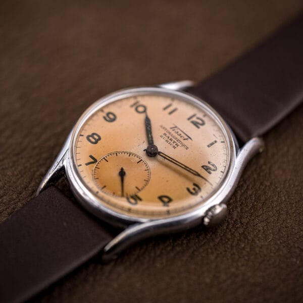 Vintage Tissot 6439-2 retailed by Barth Zurich, small seconds dial and slim chrome case on leather.
