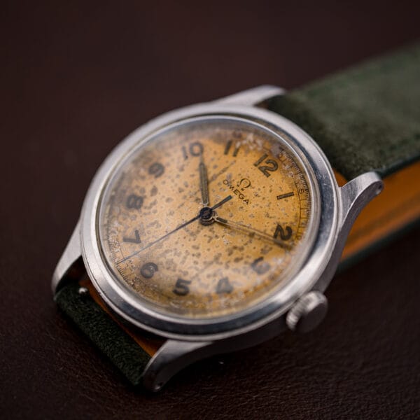 Close view of the Omega 2179/4 dial showing speckled tropical patina across the surface