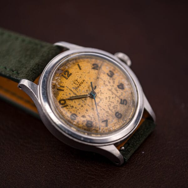Vintage Omega 30T2 SC dial detail with radium-aged numerals and blued seconds hand