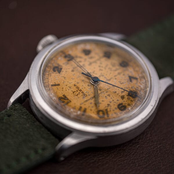 Angled macro of the Omega 30T2 SC tropical dial and OMEGA signature