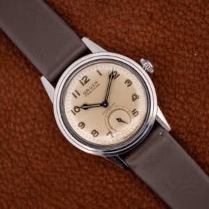 Vintage Gruen Precision Autowind on a brown leather strap, off-white luminous Arabic dial facing forward.