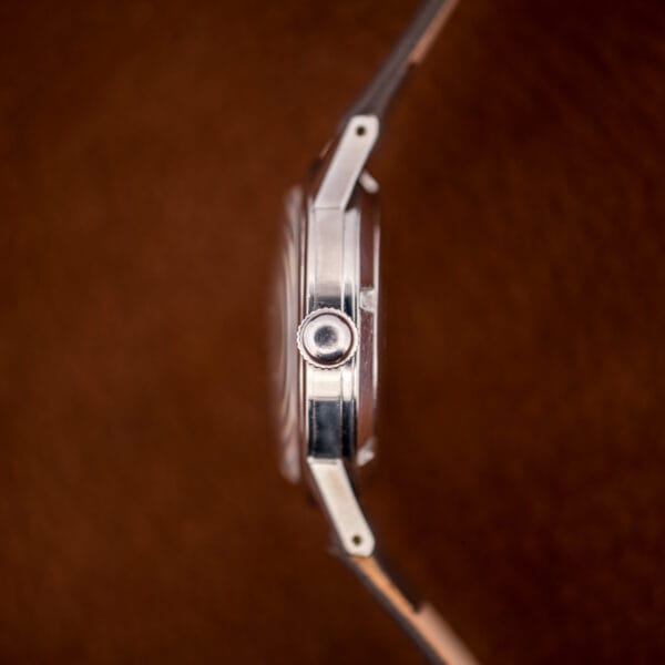 Side profile of the Gruen Precision Autowind showing the polished stainless case and signed fluted crown.