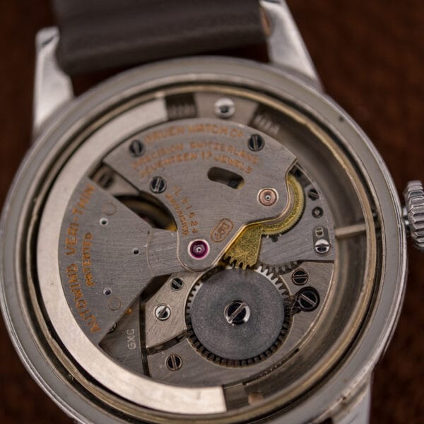 Macro of the Gruen 460 bumper movement: oval caliber stamp, Precision Switzerland engraving, and jeweled bridges.