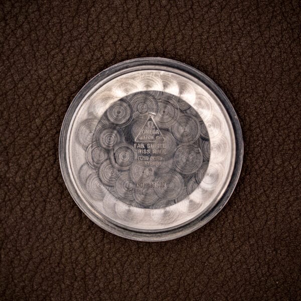 Interior of the caseback stamped Fond Acier Inoxydable and reference CD 168 023, confirming the stainless back and model.