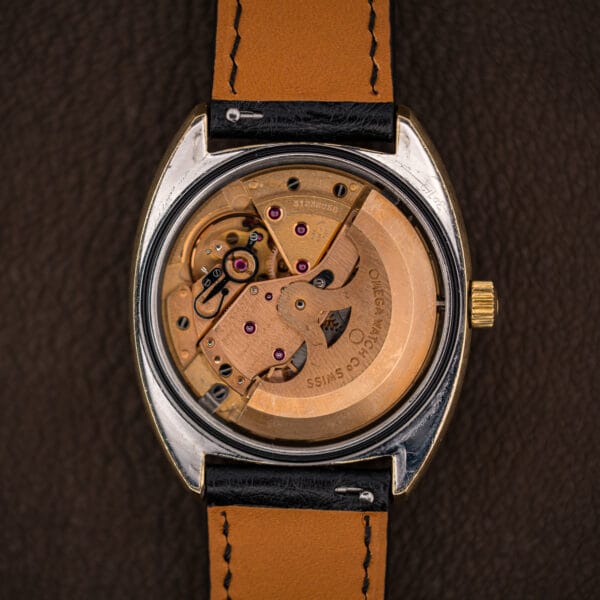 Omega caliber 751 automatic movement with copper finish, engraved rotor, jeweled bridges, and the day-date calendar works.