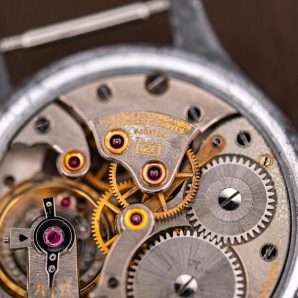 Longines 12L movement macro, caliber stamp 12L beside SEVENTEEN 17 JEWELS on the gilt-lettered bridge