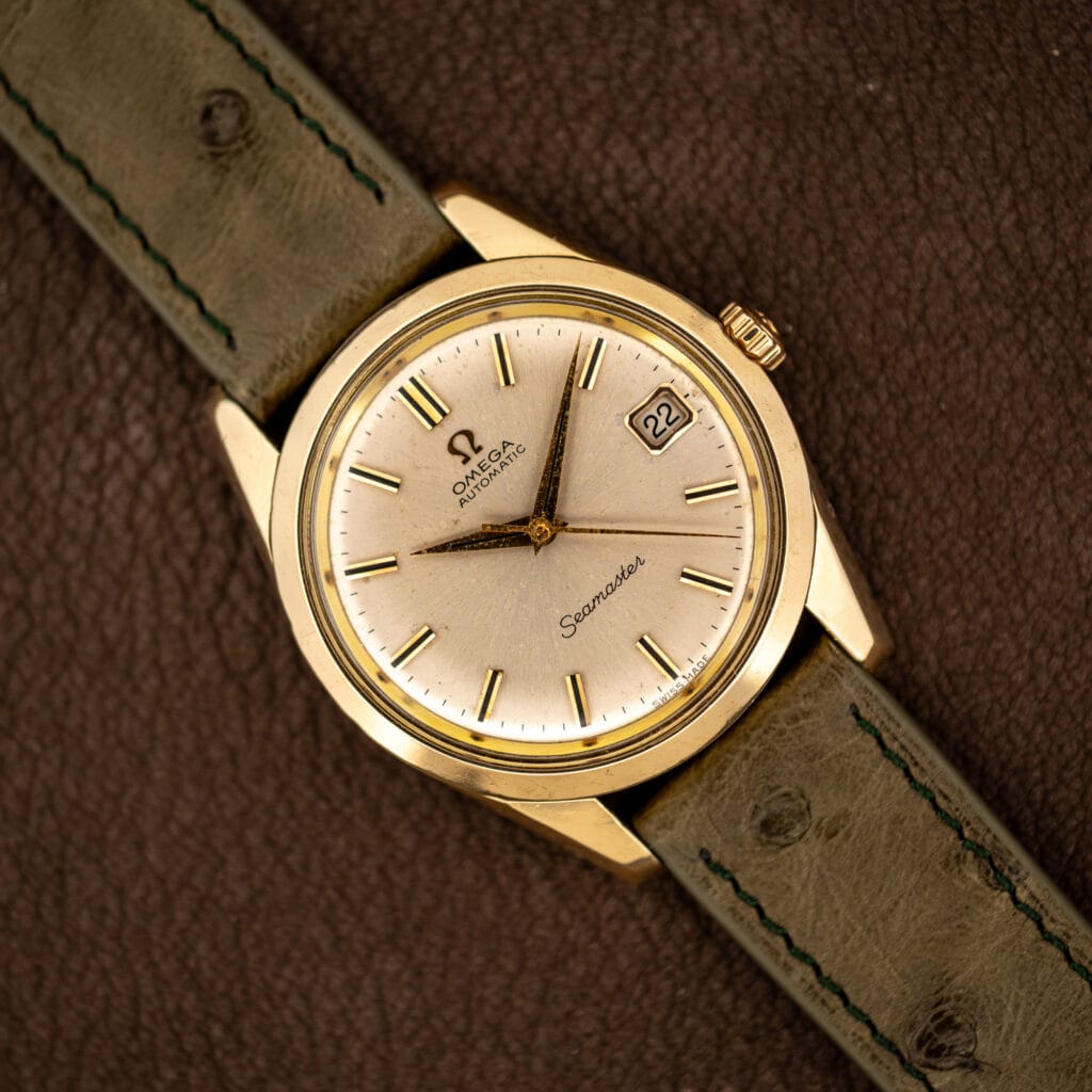 Omega Seamaster 166.010 gold capped case with silver sunburst dial, applied gold batons and date at three