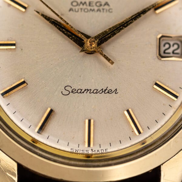 Seamaster script and SWISS MADE printing above six on the silver sunburst dial of this Omega 166.010