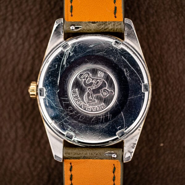 Seamaster seahorse relief inside the caseback of the Omega 166.010, with watchmaker service marks alongside