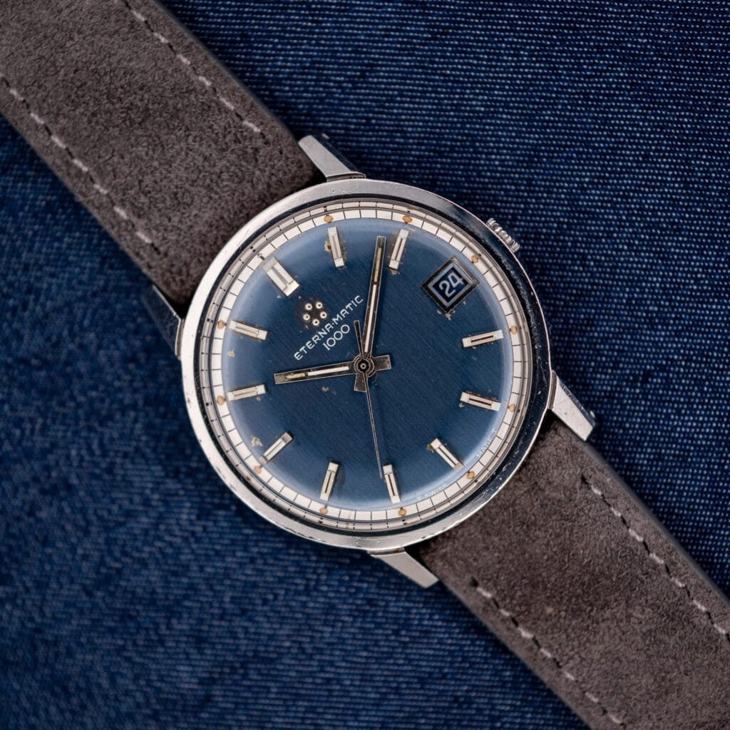 Vintage Eterna-Matic 1000 with midnight blue sunburst dial, five-dot logo and applied baton markers, front view.