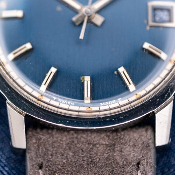 Dial macro of the Eterna-Matic 1000 showing tritium T SWISS MADE T printing and aged lume pips.