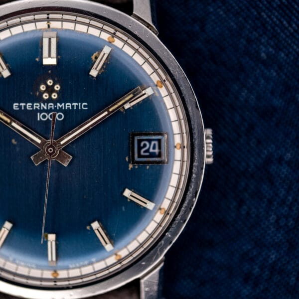 Eterna-Matic 1000 navy dial with a framed date window at three and a polished stainless steel case.